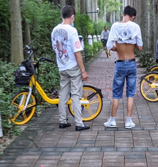 Guy with his shirt pulled up, modeling the Beijing Bikini
