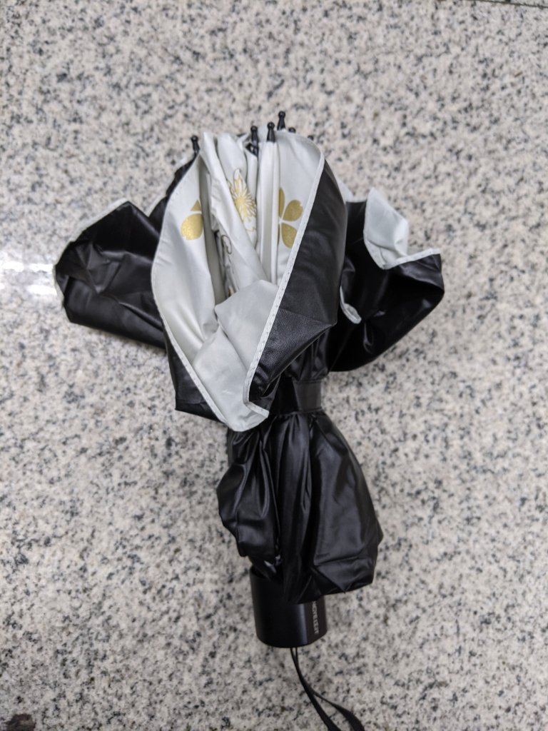 My new white and black sun umbrella with gold flowers.