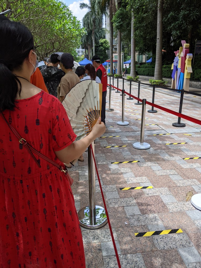 Woman in line near me with a fan.